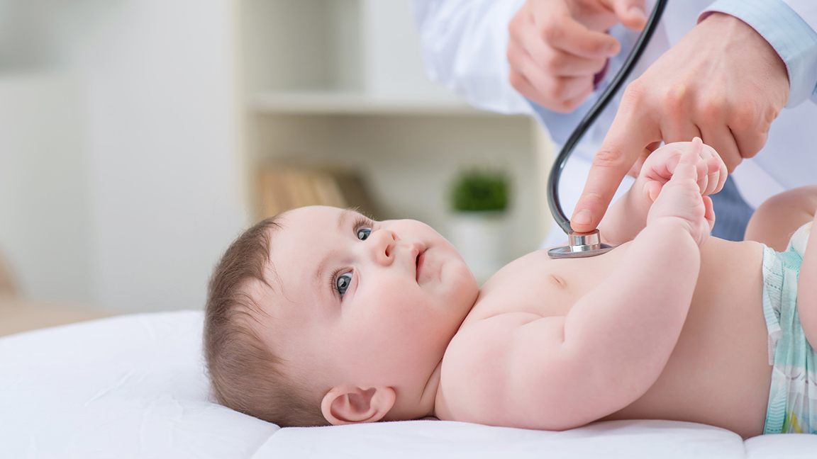 Pediatrician examining baby