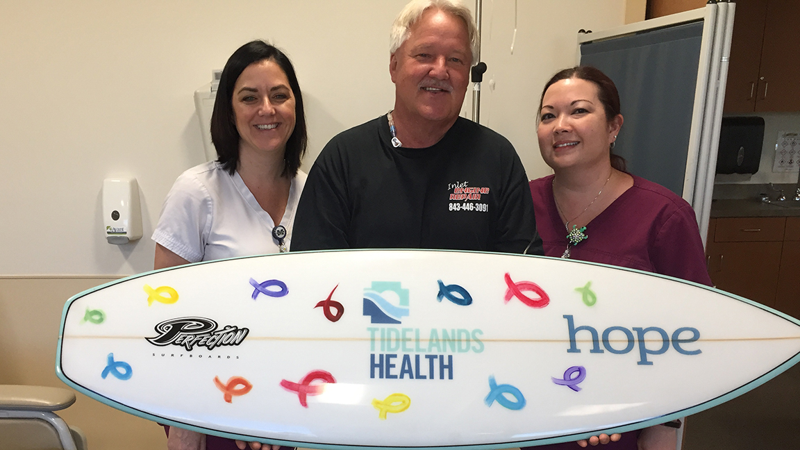Tidelands Health cancer patient Harry Muiter is joined by infusion nurses Tara Wiggins, at left in photo, and Tricia Balazs.