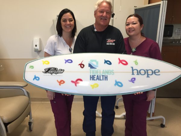 Tidelands Health cancer patient Harry Muiter is joined by infusion nurses Tara Wiggins, at left in photo, and Tricia Balazs.