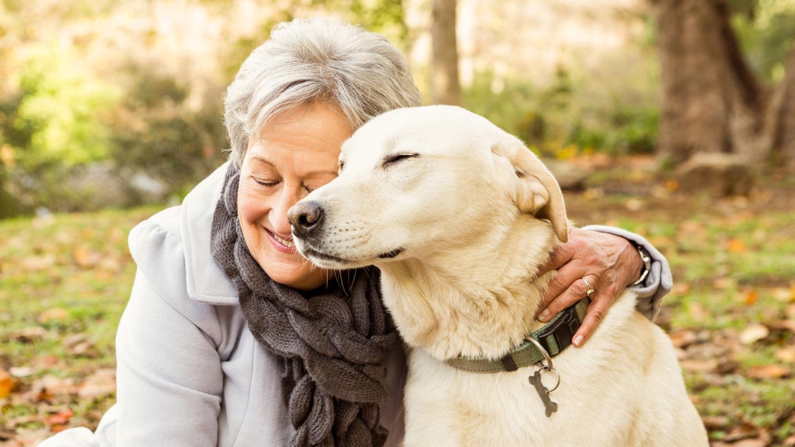 A woman hugs her dog