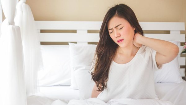 Woman rubbing painful neck