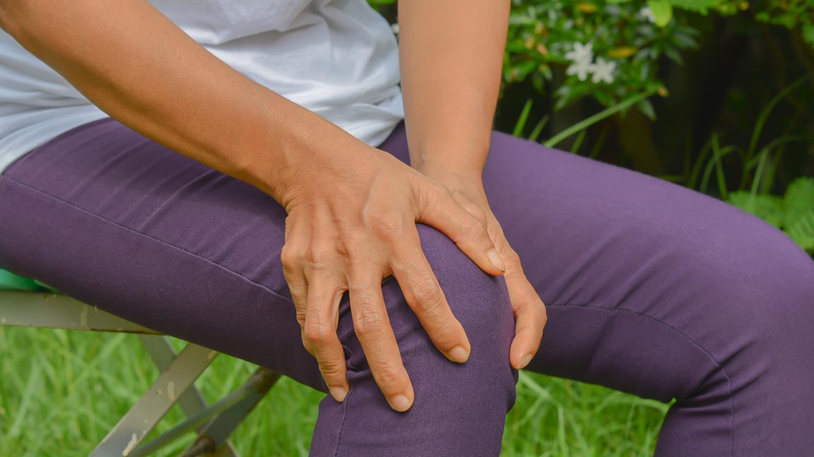 Woman with hands on her knee