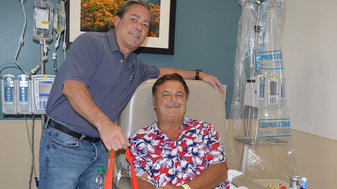 A gift bag is presented to Tidelands Health Cancer Care Network patient Ronald Breno.