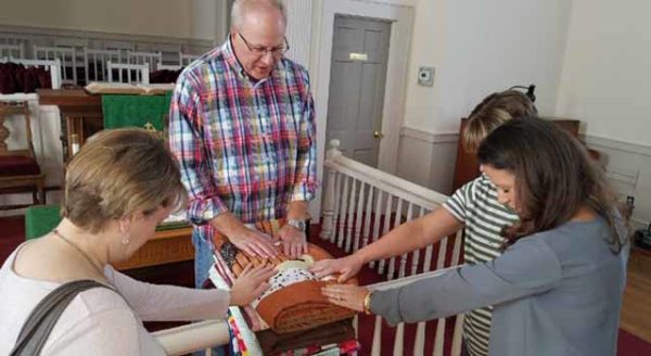 Socastee United Methodist Church Pastor Kurt McPherson blesses quilts created by the SUMC Stitchers. All quilts are blessed before they are donated.