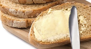 A knife spreading butter on bread