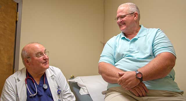 Hal James and Dr. Laurence Ballou chat inside a room at Tidelands Health Gastroenterology at Georgetown.