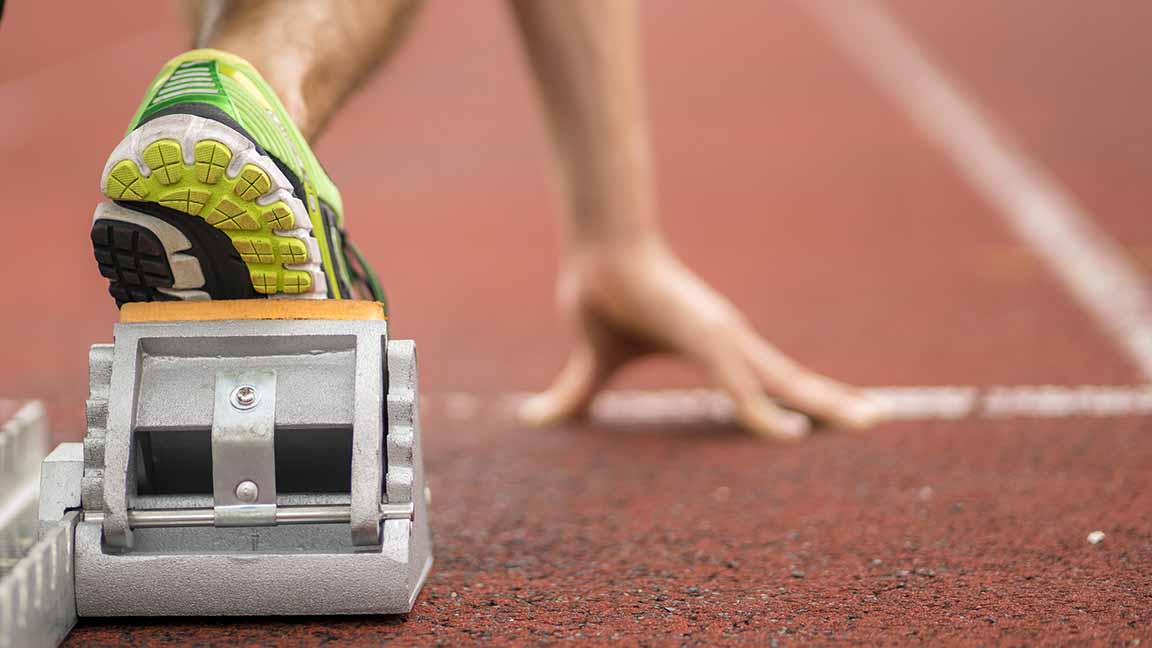 Runner at the starting line of track run.