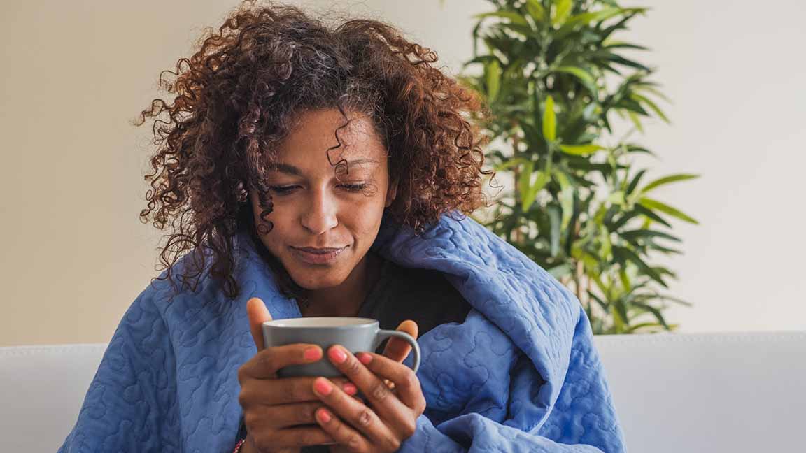 Sick woman drinking hot tea