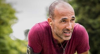 Athletic man takes a break during a run.