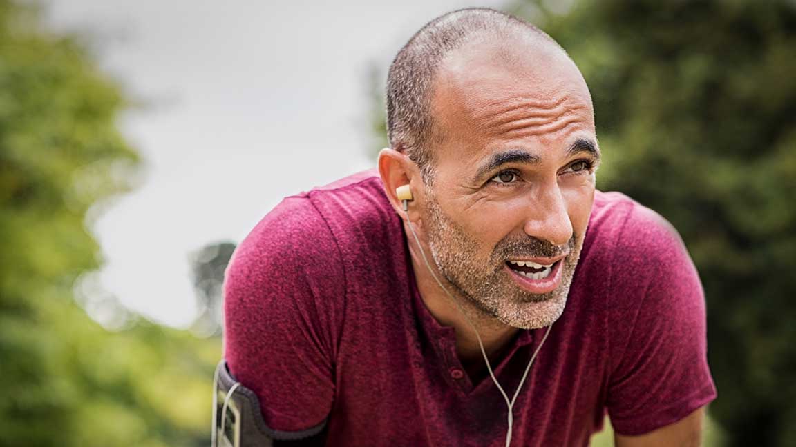 Athletic man takes a break during a run.