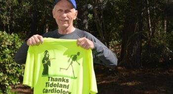 Jack Volker holds up a special shirt he had created to thank the team at Tidelands Health for the care he received.