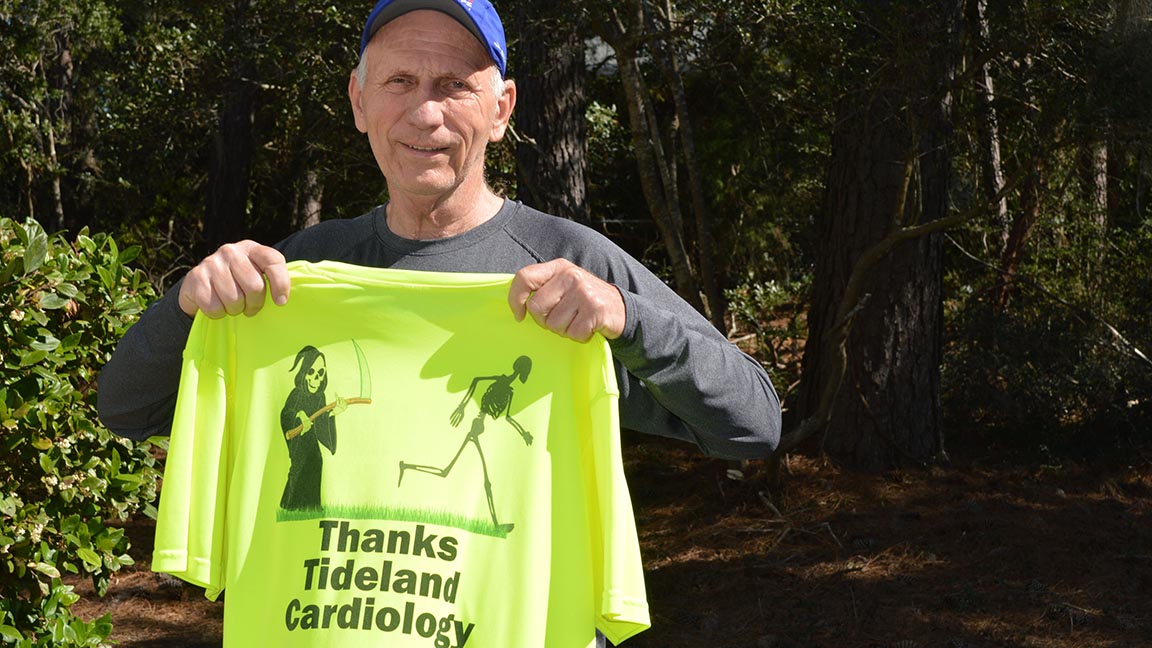 Jack Volker holds up a special shirt he had created to thank the team at Tidelands Health for the care he received.