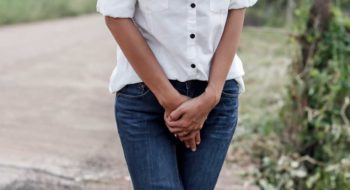 Woman struggling with bladder incontinence after birth.