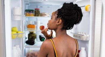 Woman near fridge.