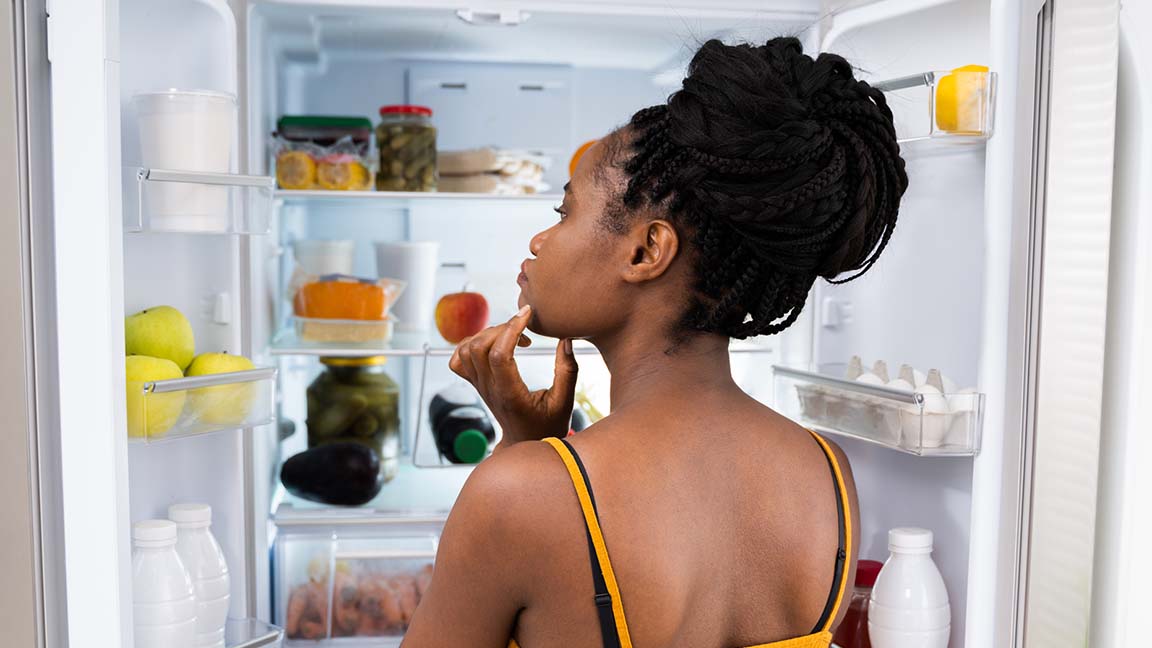 Woman near fridge.
