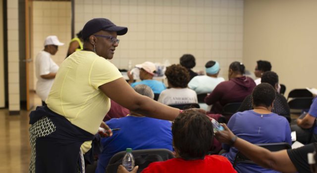 Eliza Linen distributes water to participants in the Tidelands Health diabetes prevention program, many of whom walked laps in the gym prior to meeting. Linen graduated from the program in 2018 but still attends classes for camaraderie and support.