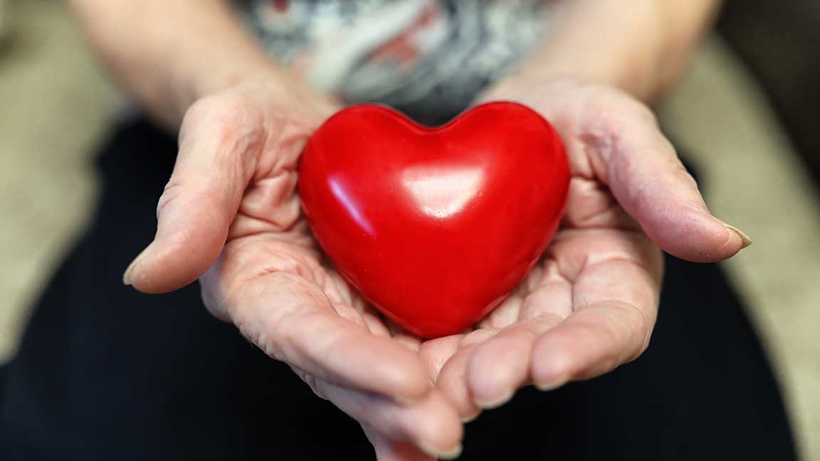 Woman holds a heart.