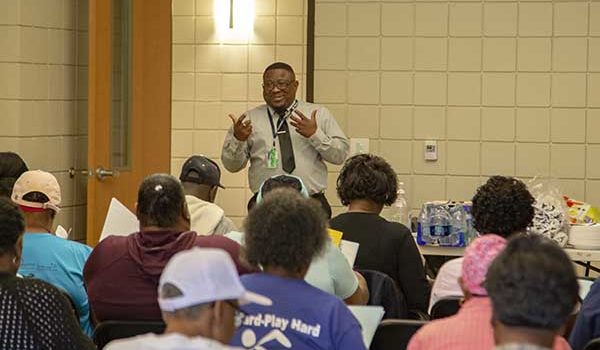 Shawn Garrett, a community health worker at Tidelands Community Care Network, teaches a diabetes prevention program class focused on portion control.
