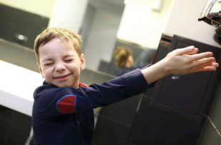 Boy drying his hands in a restroom