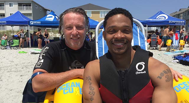 Ernie Johnson with his surfing partner, Tyler Watkins.