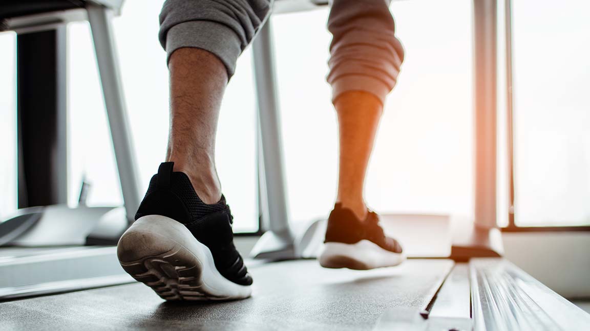 Close up on shoe,Man running in a gym on a treadmill.exercising concept.fitness and healthy lifestyle