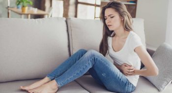 Woman struggles with abdominal pain.