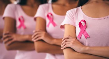 Women wearing pink ribbons.