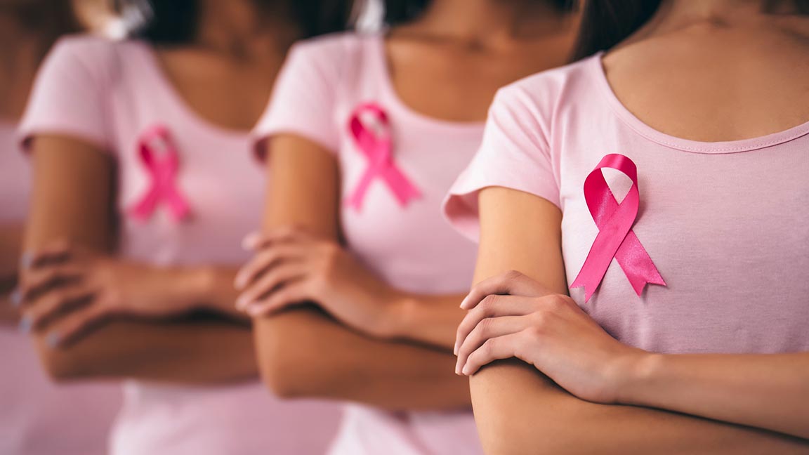 Women wearing pink ribbons.