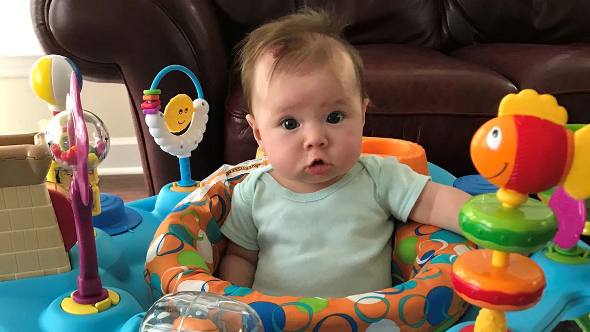Luna enjoys some time in her exersaucer.