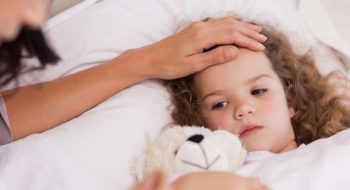 Young mother taking care of her ill daughter