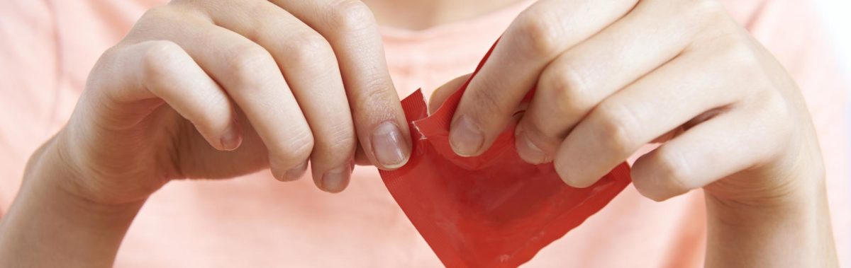 Woman Adding Artificial Sweetener To Coffee