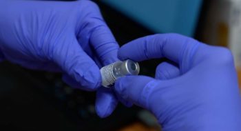 Hands holding COVID-19 vaccine