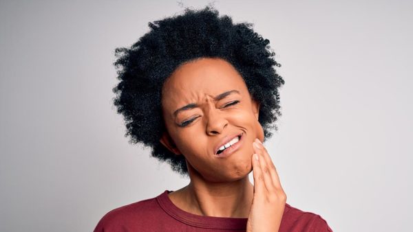 Young woman suffering from mouth pain.