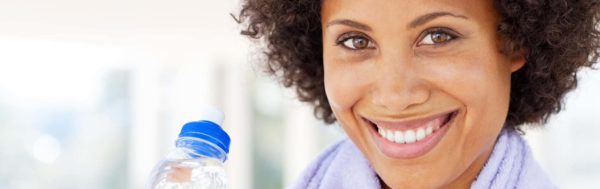 Woman holding bottle of water after workout