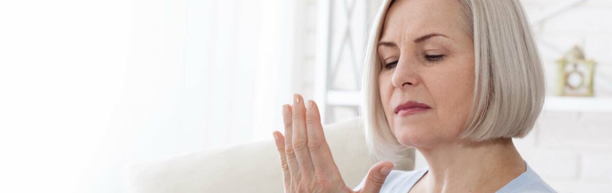 Woman massaging cold hands.