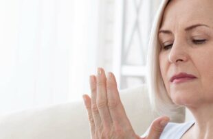 Woman massaging cold hands.