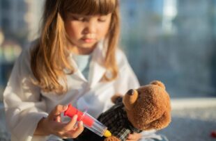 Little girl playing doctor.