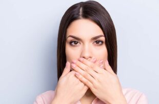 Woman covering mouth