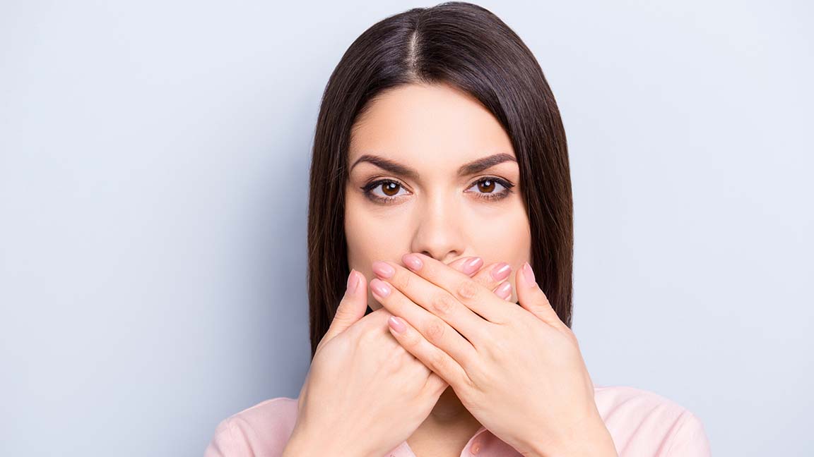 Woman covering mouth