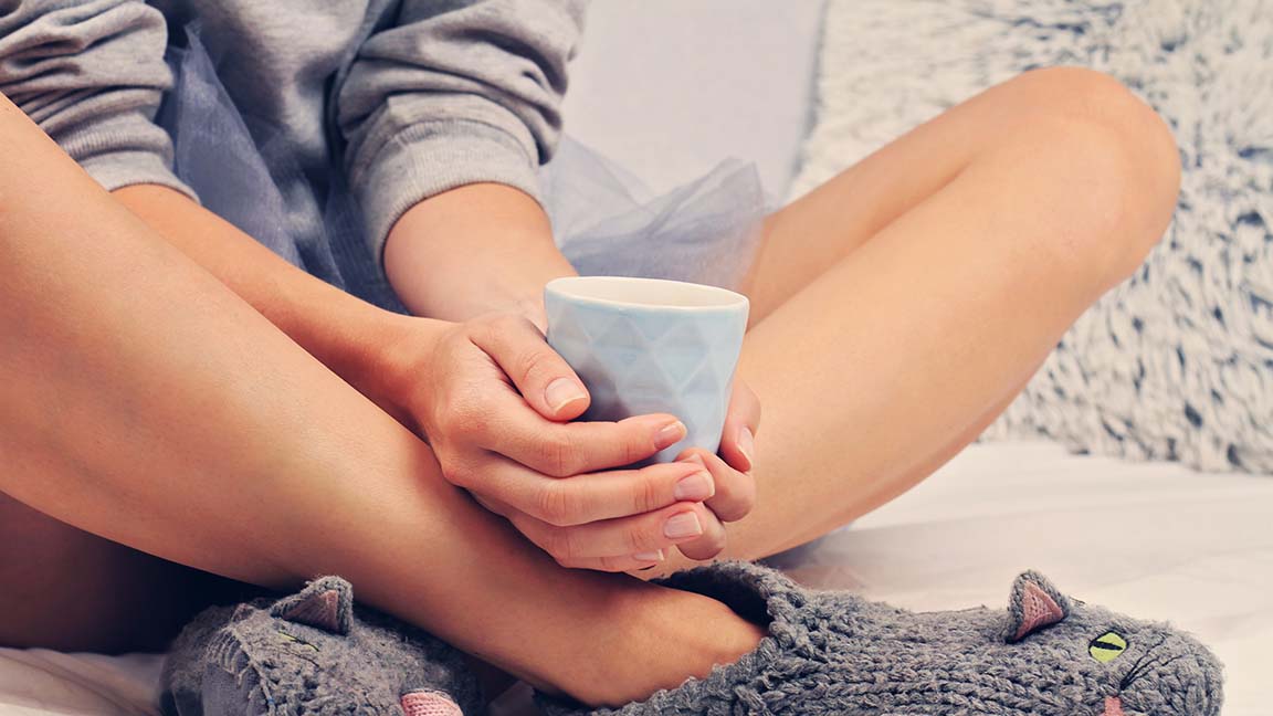 Woman wearing cozy warm wool socks close up. Warmth concept. Winter clothes