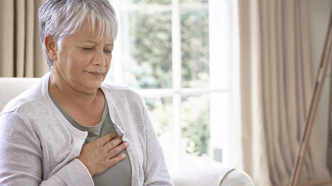 Woman with hand over her heart
