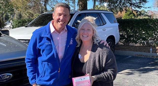 Local celebrity Ed Piotrowski presented Fisher with a bobblehead featuring him wearing a pink suit for breast cancer awareness.