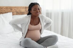 Expectant mother struggling with back pain