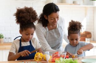 Woman cooking with her children.