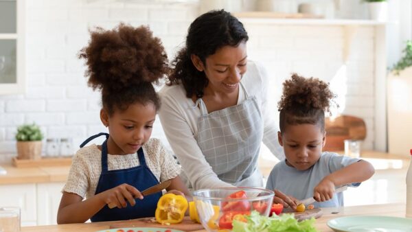 Woman cooking with her children.