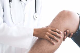 Doctor checking patient with knees to determine the cause of illness.