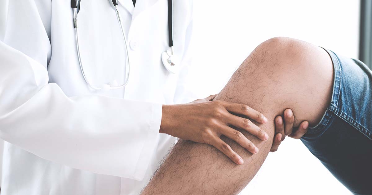 Doctor checking patient with knees to determine the cause of illness.