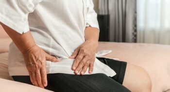 Senior woman struggling with hip pain.
