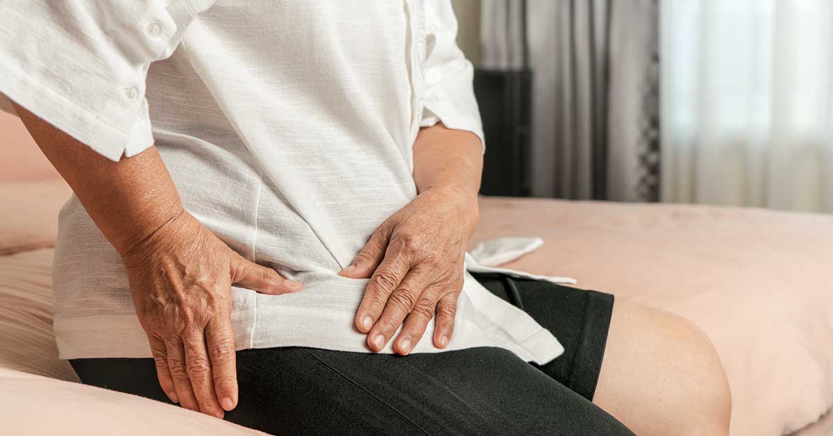 Senior woman struggling with hip pain.