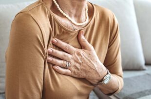 Woman with hand to chest